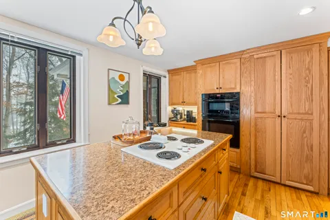 a kitchen with stove and refrigerator