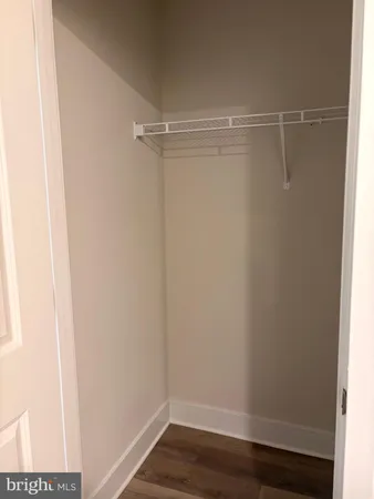 a view of hallway with closet and bathroom