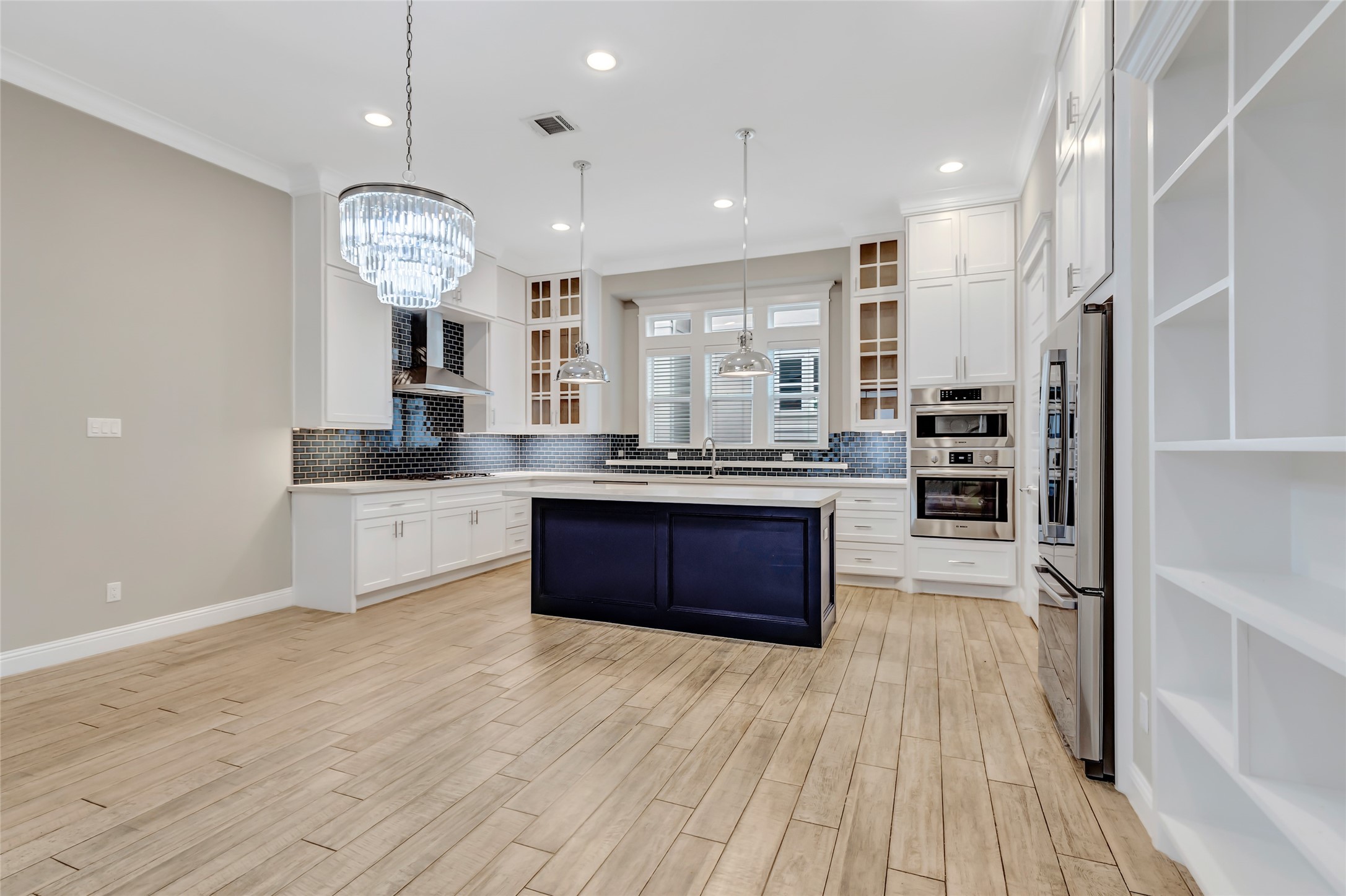 2810 Princeton Street Houston, TX 77009 - Photo 12 of 31 a large kitchen with stainless steel appliances a large counter top a stove and a wooden floors
