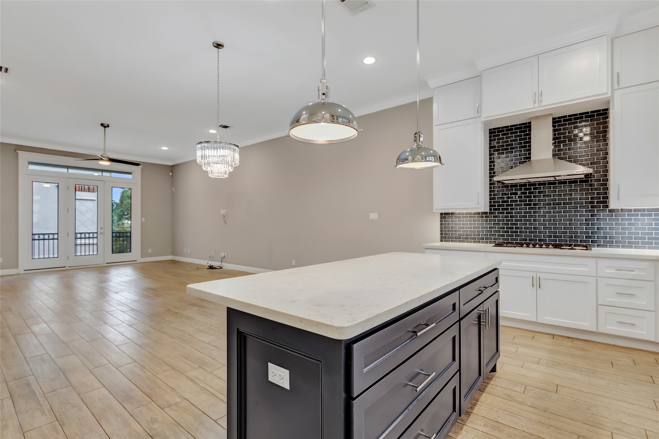 2810 Princeton Street Houston, TX 77009 - Photo 15 of 31 a kitchen with a stove chandelier and wooden floor