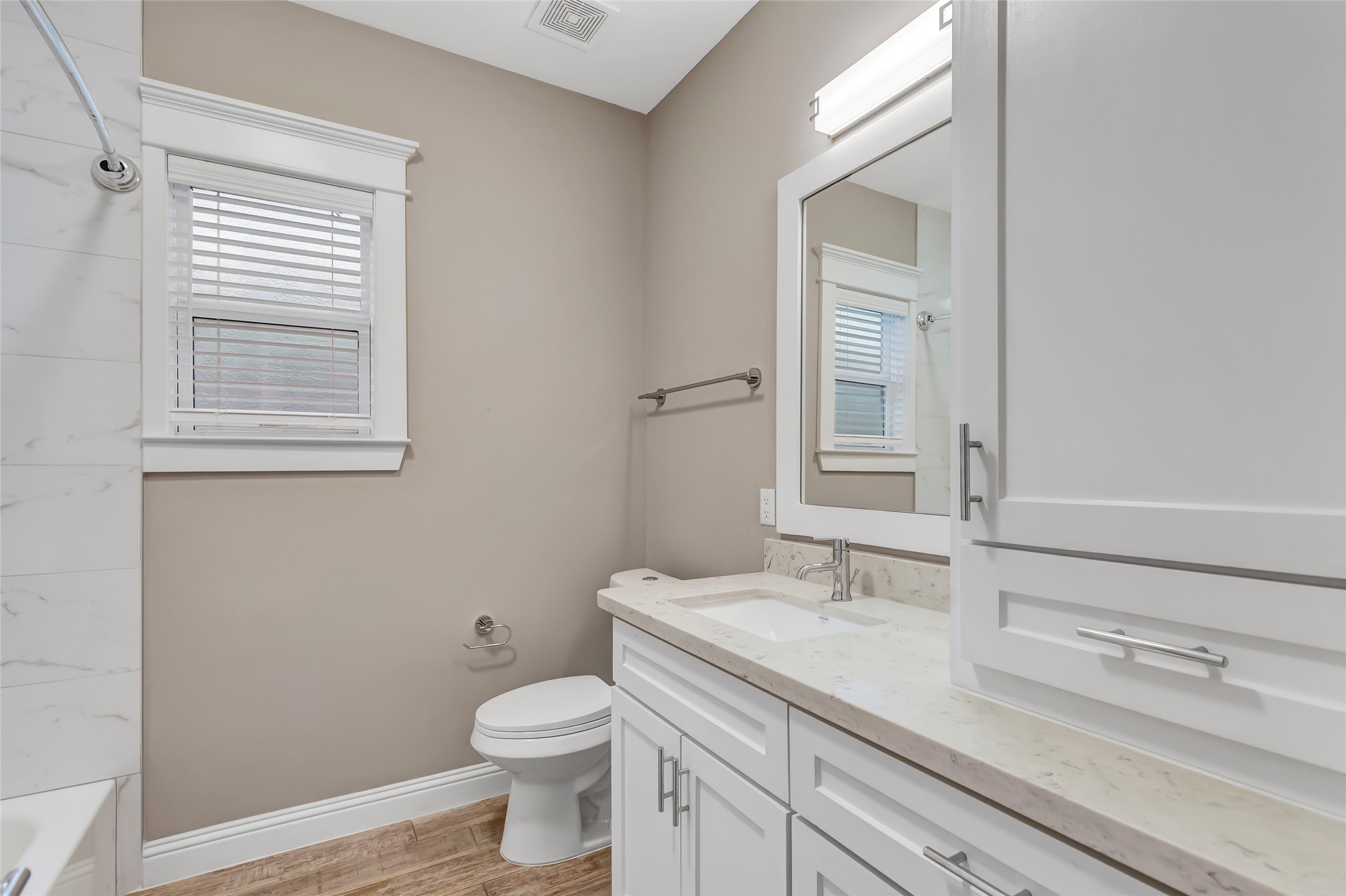 2810 Princeton Street Houston, TX 77009 - Photo 30 of 31 a bathroom with a granite countertop toilet sink and mirror
