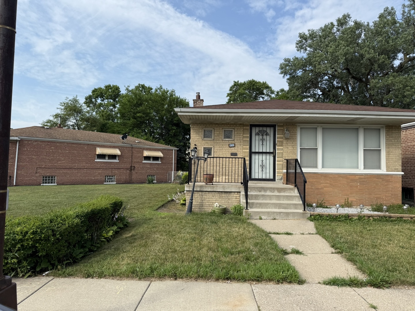 8114 South Anthony Avenue Chicago, IL 60617 - Photo 25 of 25 a front view of a house with a garden