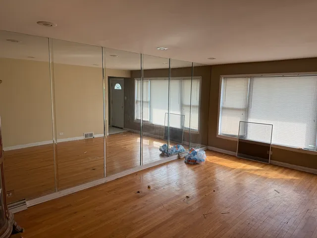 a view of a room with gym equipment and a large window