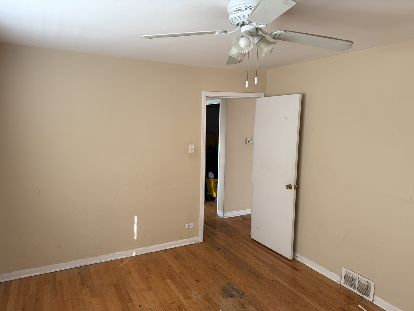 8114 South Anthony Avenue Chicago, IL 60617 - Photo 5 of 25 an empty room with wooden floor ceiling fan and window