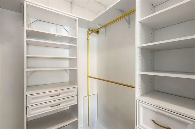 a bathroom with a granite countertop sink a mirror a bathtub and shower