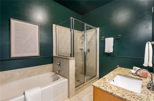 a bathroom with a granite countertop sink toilet and mirror