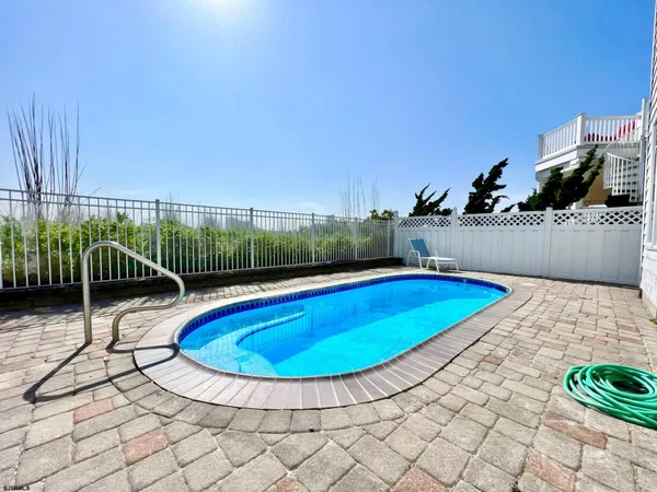 a view of a swimming pool with a lounge chair