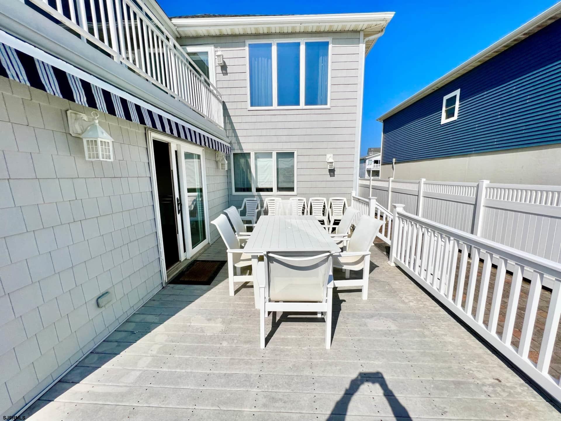 24 Ocean Drive West Brigantine, NJ 08203 - Photo 20 of 48 a view of a house with wooden deck and furniture