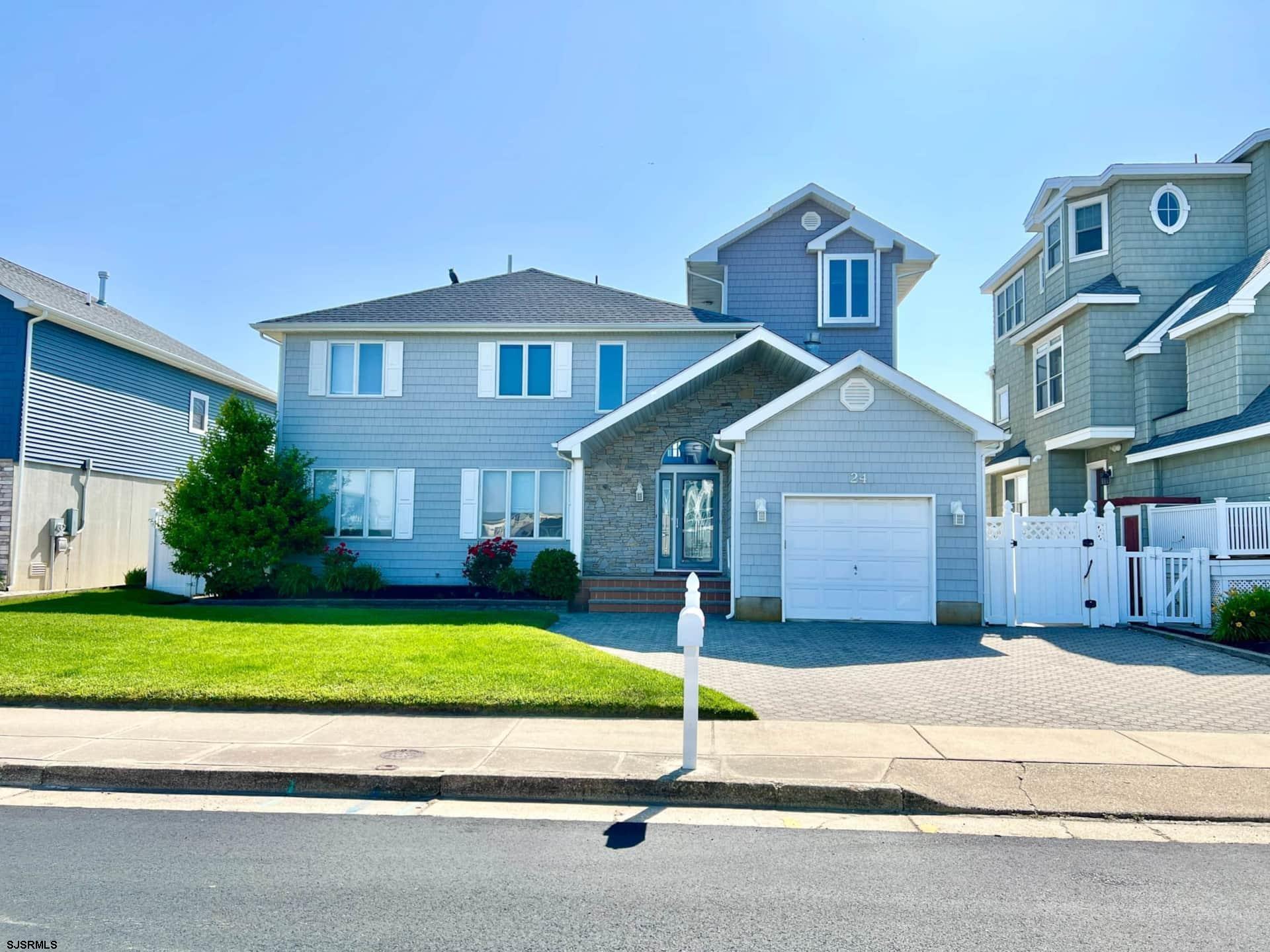 24 Ocean Drive West Brigantine, NJ 08203 - Photo 2 of 48 a house with a yard and a large parking space