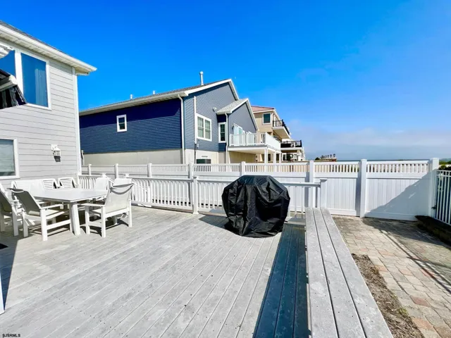 a view of a patio with table and chairs with wooden floor