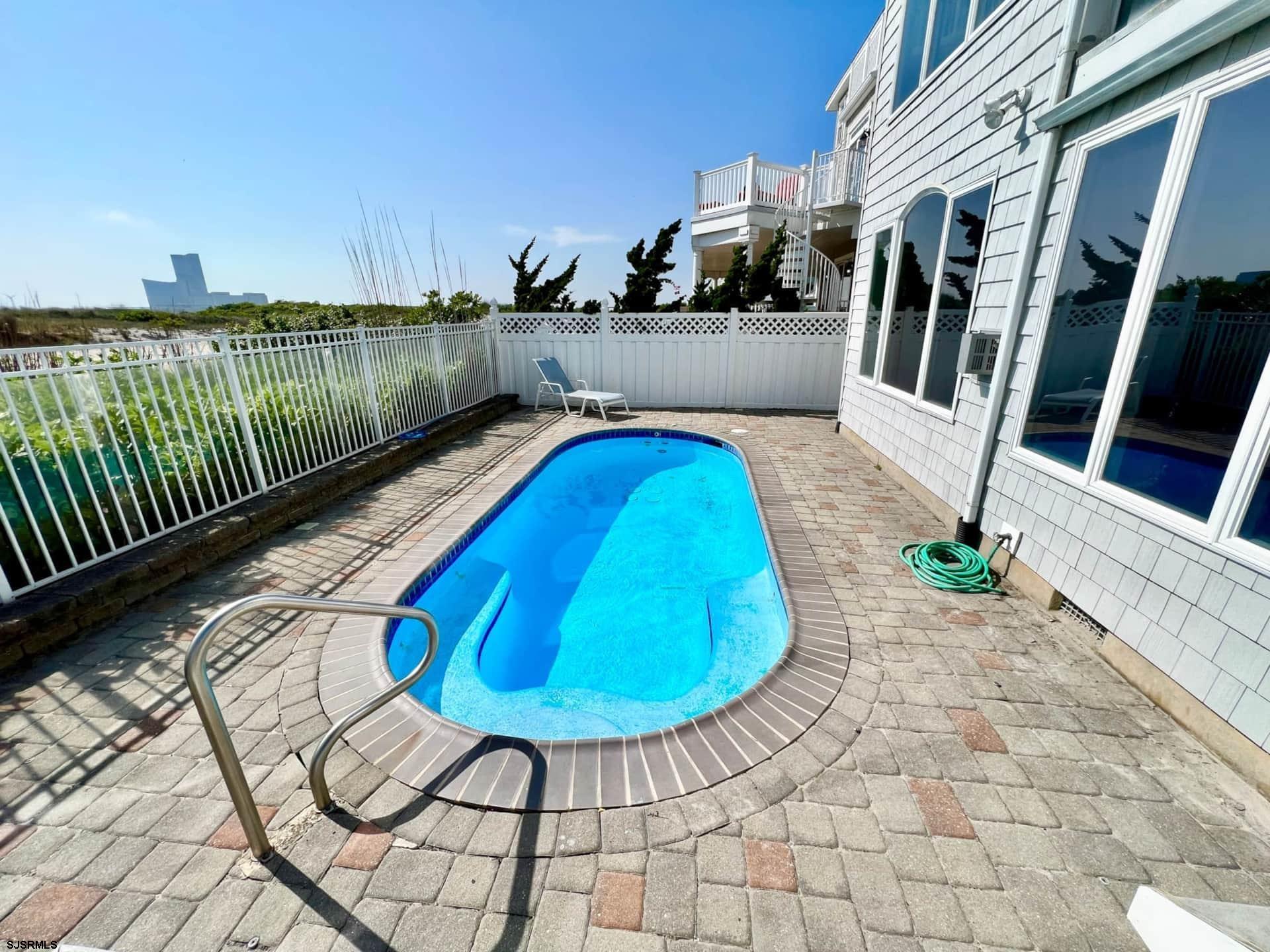 24 Ocean Drive West Brigantine, NJ 08203 - Photo 23 of 48 a view of a swimming pool with a patio