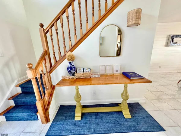 a living room with table chairs and wooden floor