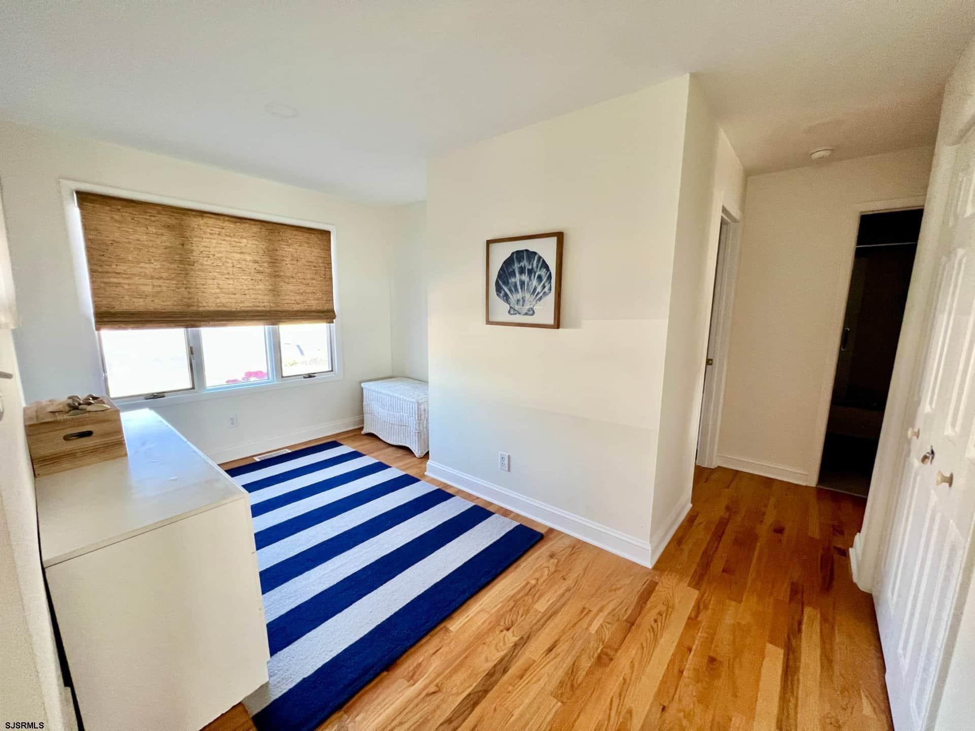 24 Ocean Drive West Brigantine, NJ 08203 - Photo 29 of 48 a bedroom with a bed and a window