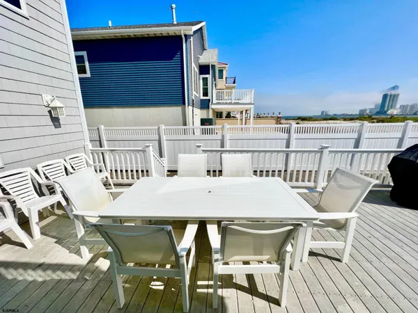 a roof deck with a table and chairs