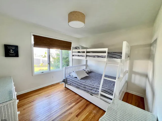 a living room with a rug floor and a large window
