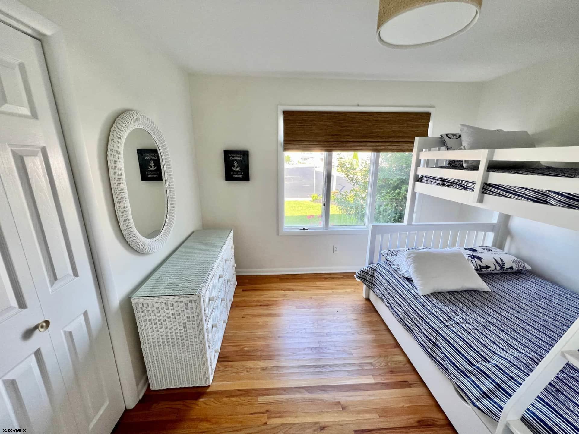 24 Ocean Drive West Brigantine, NJ 08203 - Photo 31 of 48 a bedroom with furniture and a wooden floor