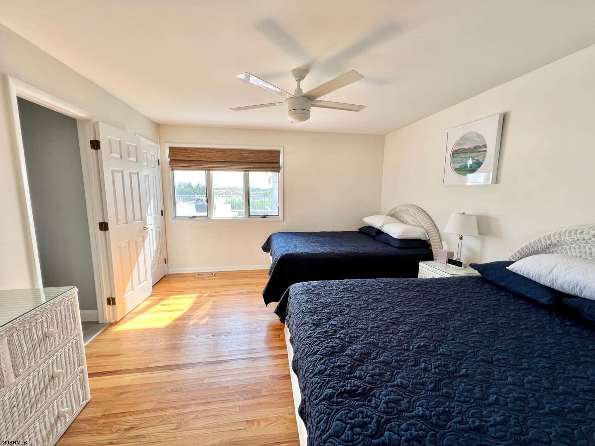 24 Ocean Drive West Brigantine, NJ 08203 - Photo 33 of 48 a bedroom with a large bed and a window