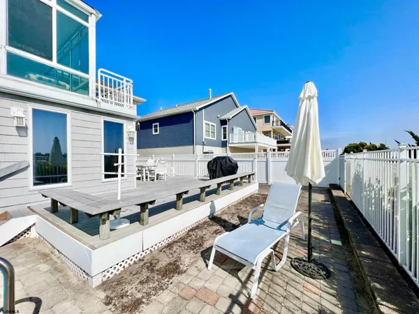 a front view of a house with outdoor seating