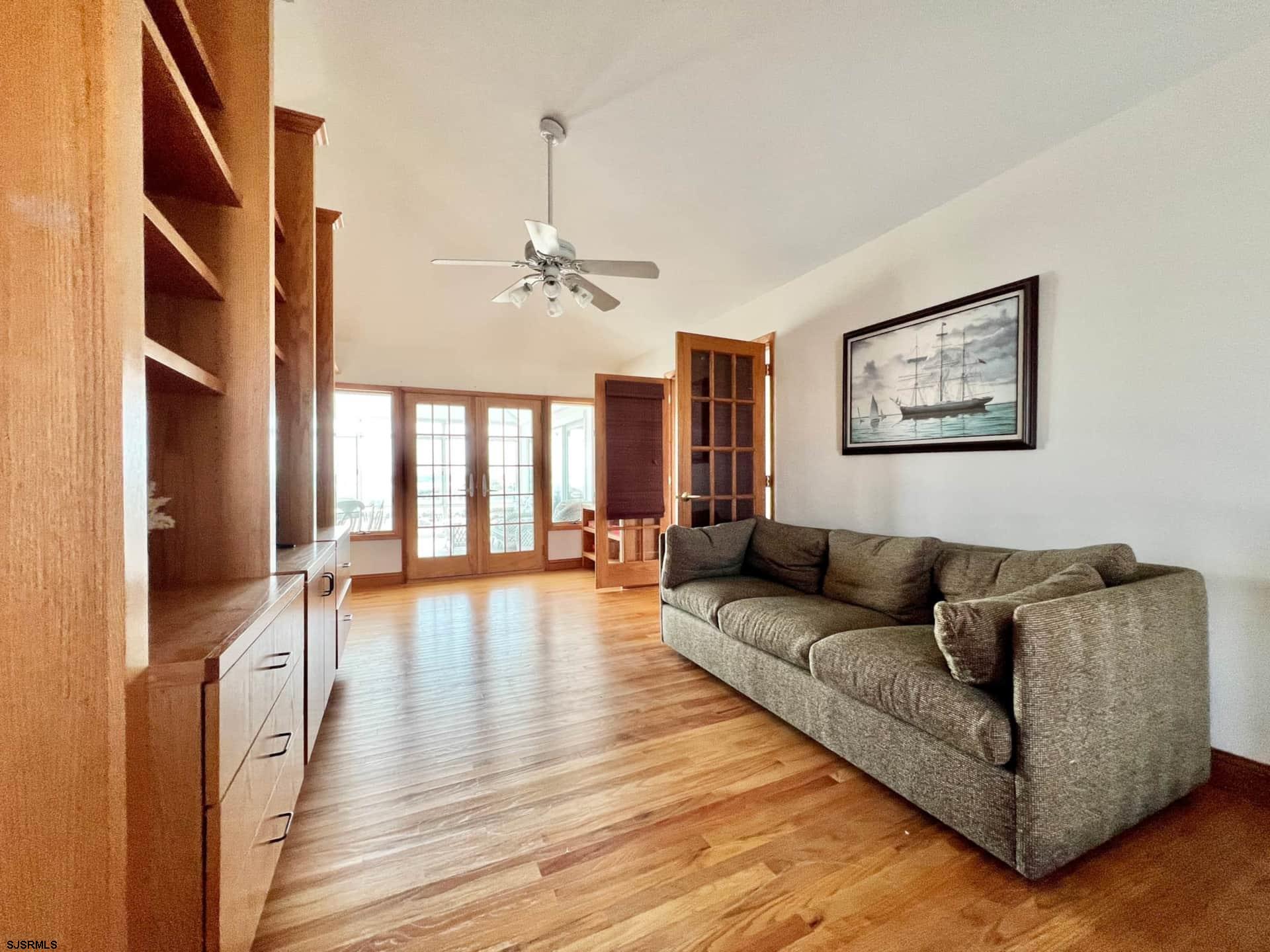 24 Ocean Drive West Brigantine, NJ 08203 - Photo 38 of 48 a living room with furniture and a chandelier