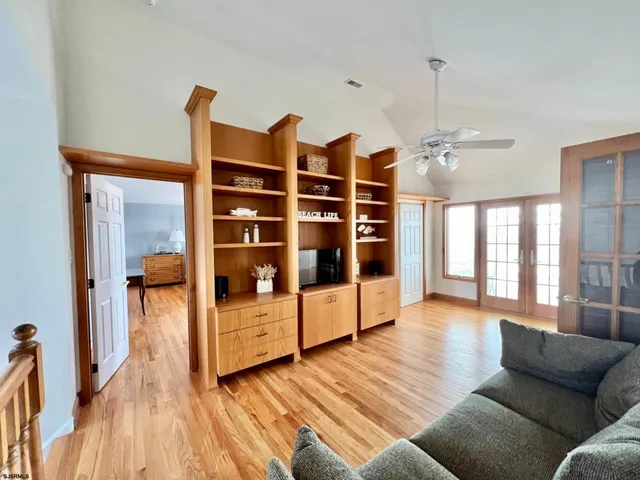 a living room with furniture hardwood floor and a table