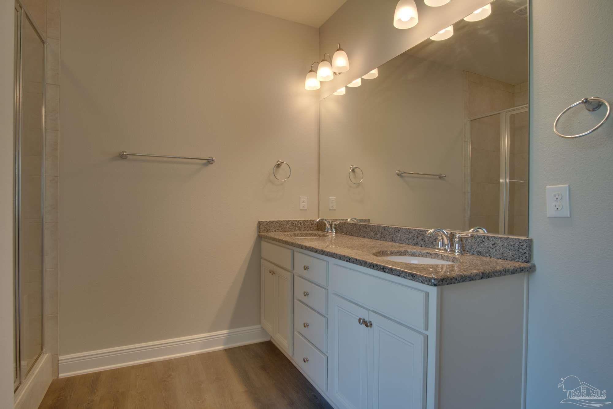 6239 Ladera Trail Pace, FL 32571 - Photo 17 of 27 a bathroom with a granite countertop sink and a mirror