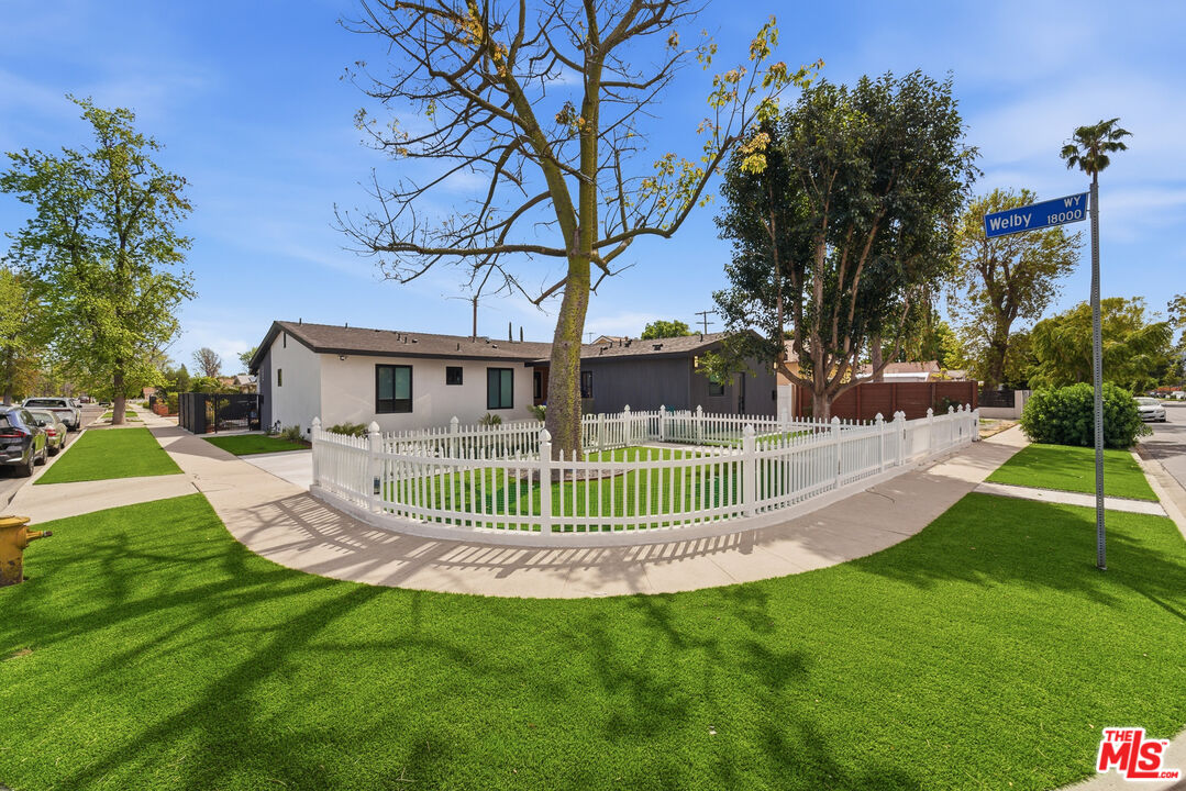6724 Hesperia Avenue Reseda, CA 91335 - Photo 1 of 5 a front view of a house with a garden and plants