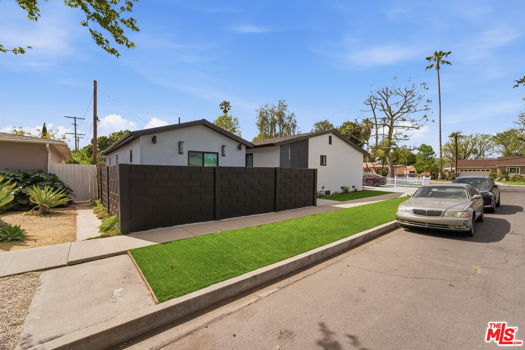 6724 Hesperia Avenue Reseda, CA 91335 - Photo 5 of 5 a car parked in front of house with a yard