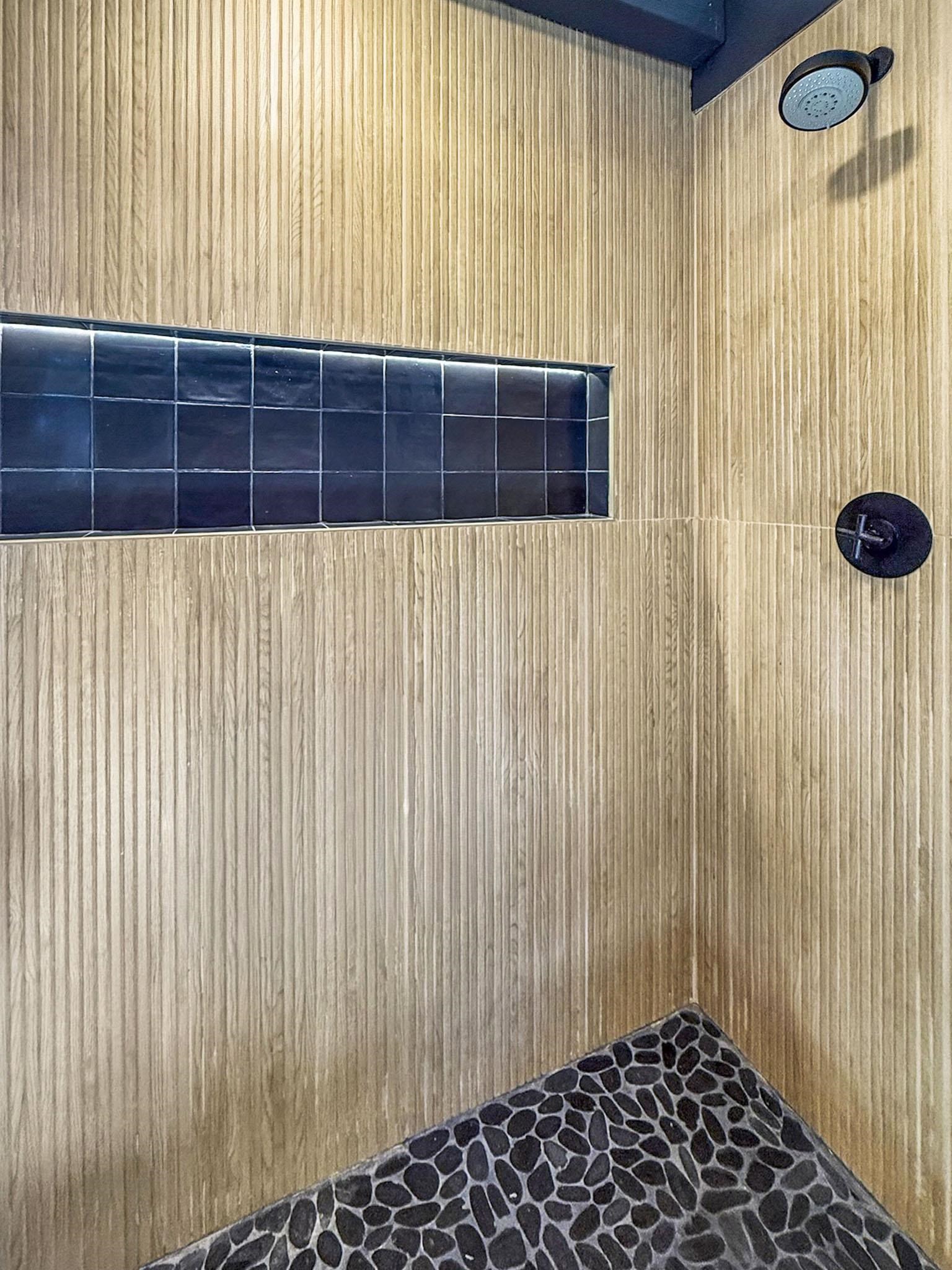 2570 Old Mammoth Road Mammoth Lakes, CA 93546 - Photo 17 of 39 Shower featuring textured wood-finish wall tiling and a river rock tiled floor