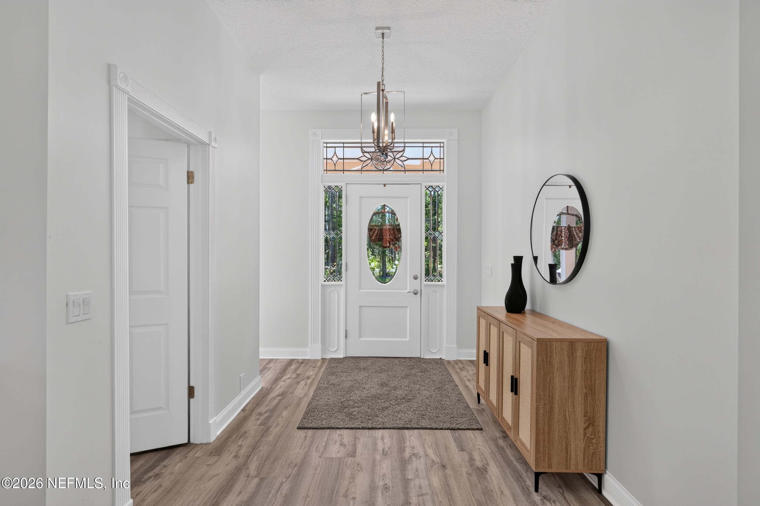 3090 Monument Bay Road St. Augustine, FL 32092 - Photo 4 of 56 a view of a hallway with wooden floor and entryway