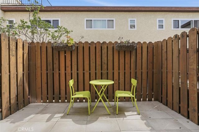 a front view of a house with chairs and table