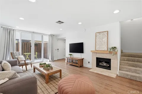 a living room with furniture flat screen tv and a fireplace