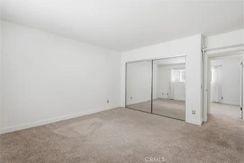 an empty room with sliding glass door and shower
