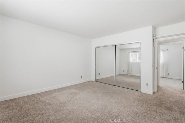 an empty room with sliding glass door and shower
