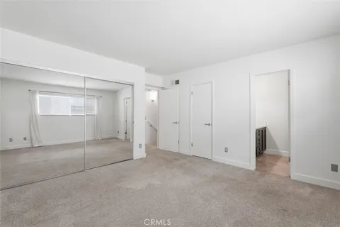 an empty room with a empty space and windows