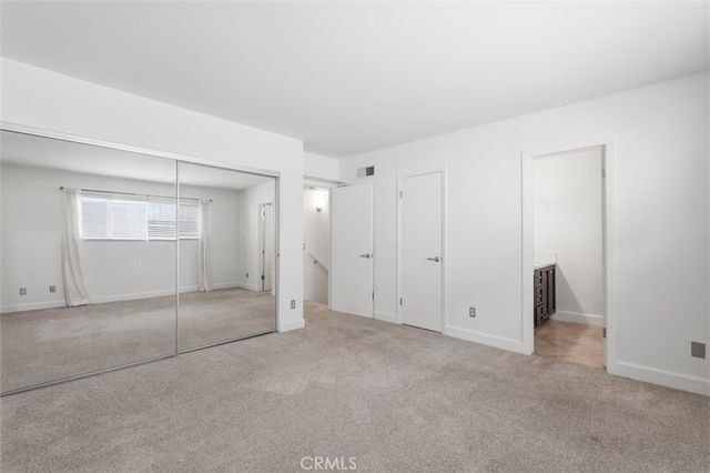 an empty room with a empty space and windows