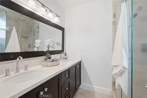 a bathroom with a double vanity sink and a mirror