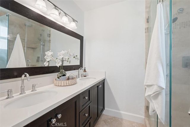 a bathroom with a double vanity sink and a mirror