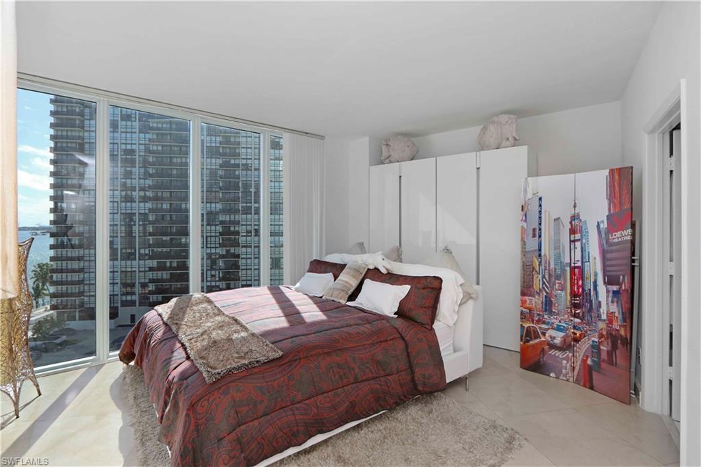 601 Northeast 36th Street, Unit 712 Miami, FL 33137 - Photo 13 of 28 a bedroom with a bed and a large window