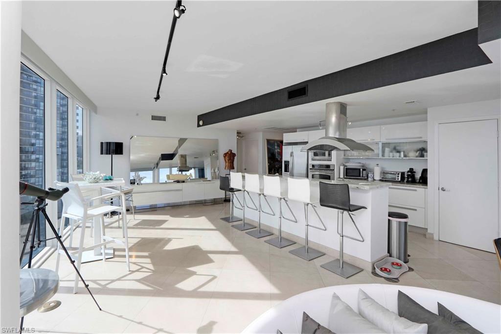 601 Northeast 36th Street, Unit 712 Miami, FL 33137 - Photo 20 of 28 a living room with furniture and white walls