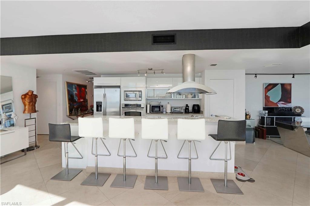 601 Northeast 36th Street, Unit 712 Miami, FL 33137 - Photo 21 of 28 a living room with furniture a flat screen tv and kitchen view