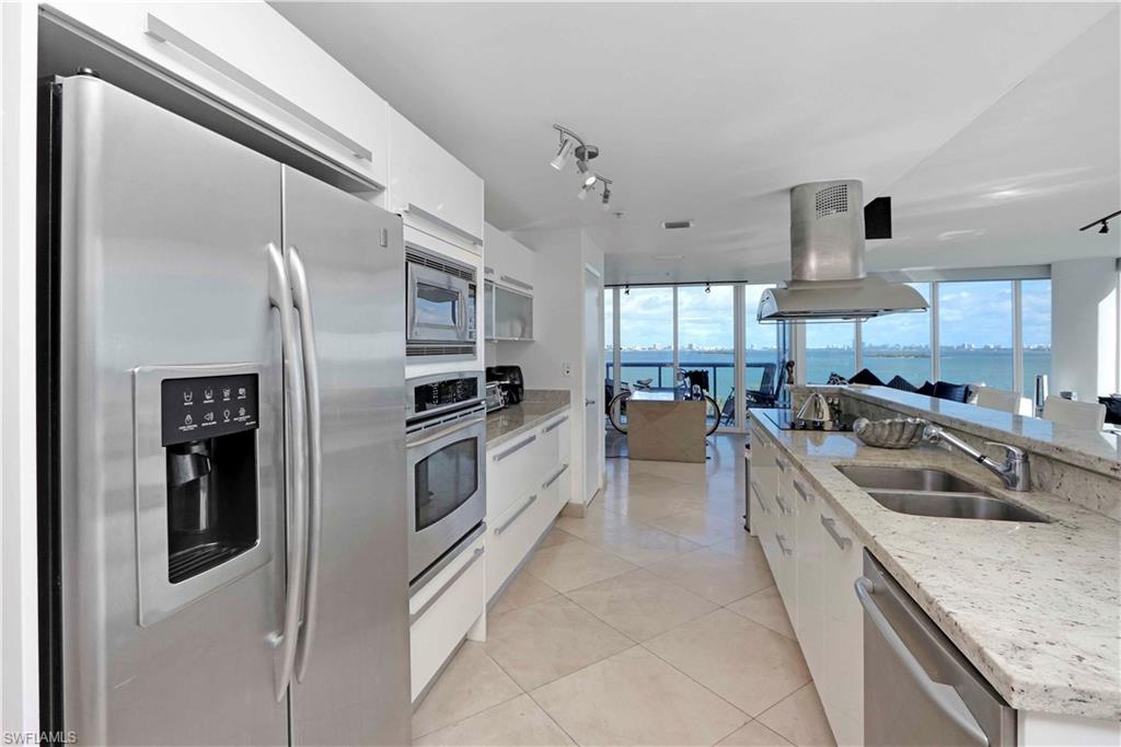 601 Northeast 36th Street, Unit 712 Miami, FL 33137 - Photo 22 of 28 a kitchen with stainless steel appliances granite countertop a sink and a refrigerator