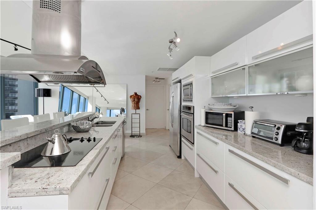 601 Northeast 36th Street, Unit 712 Miami, FL 33137 - Photo 23 of 28 a kitchen with stainless steel appliances granite countertop a stove and a sink
