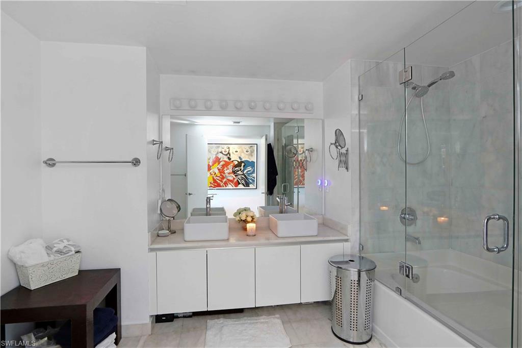 601 Northeast 36th Street, Unit 712 Miami, FL 33137 - Photo 8 of 28 a bathroom with a tub sink and mirror