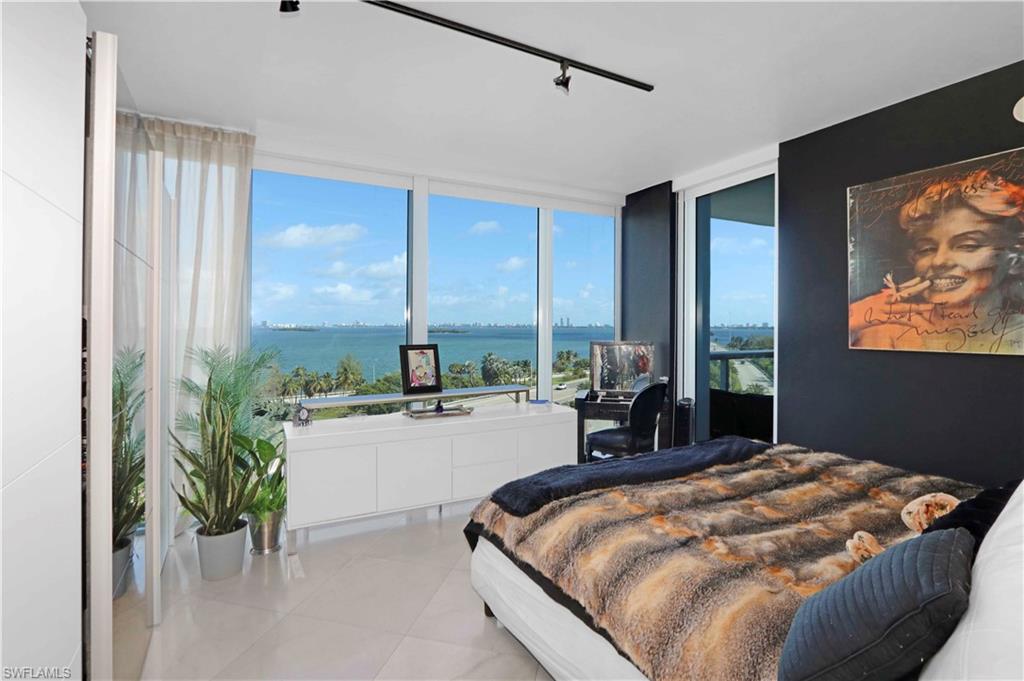 601 Northeast 36th Street, Unit 712 Miami, FL 33137 - Photo 9 of 28 a bed sitting in a spacious bedroom next to a window