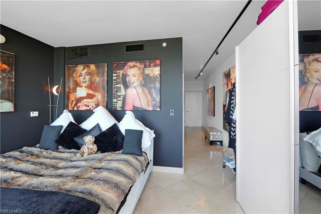 601 Northeast 36th Street, Unit 712 Miami, FL 33137 - Photo 10 of 28 a bedroom with a bed and large windows