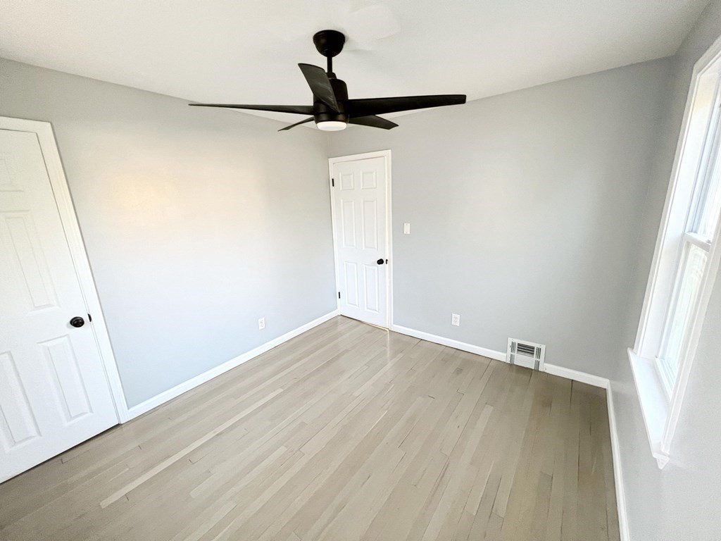 145 Powell Avenue Springfield, MA 01118 - Photo 6 of 10 wooden floor in an empty room with a window