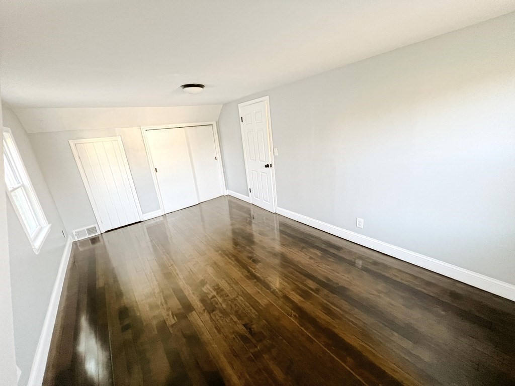145 Powell Avenue Springfield, MA 01118 - Photo 10 of 10 an empty room with wooden floor