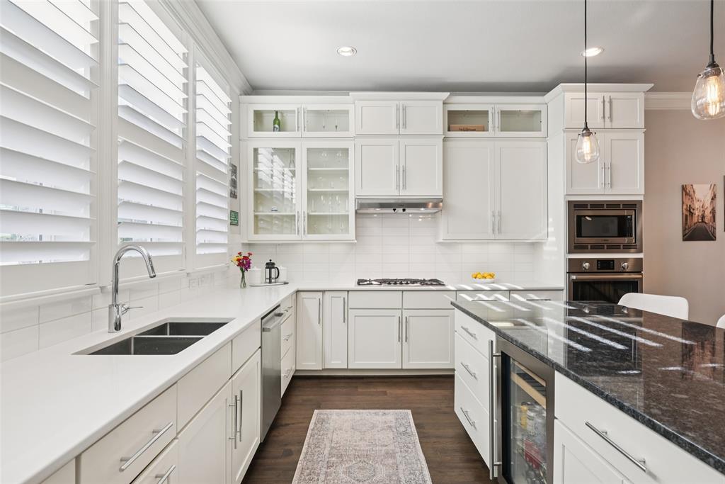 2815 Lynlock Court Dallas, TX 75219 - Photo 12 of 39 a kitchen with stainless steel appliances granite countertop a sink stove and refrigerator
