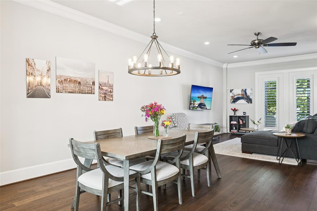 2815 Lynlock Court Dallas, TX 75219 - Photo 13 of 39 a dining room with wooden floor a chandelier a glass table and chairs