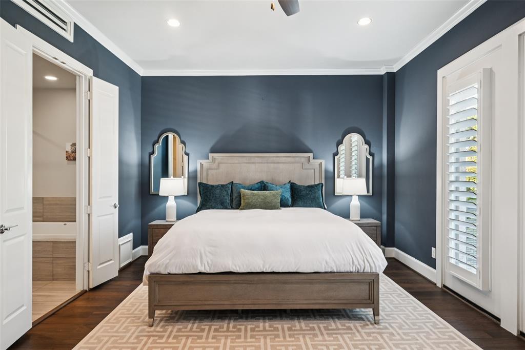 2815 Lynlock Court Dallas, TX 75219 - Photo 17 of 39 a bedroom with a large bed and a chandelier